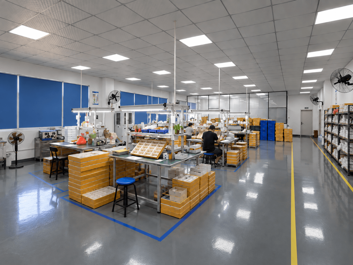 Eyewear production workshop with workstations and packing trays